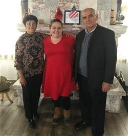 Clancy standing with her host parents in Albania