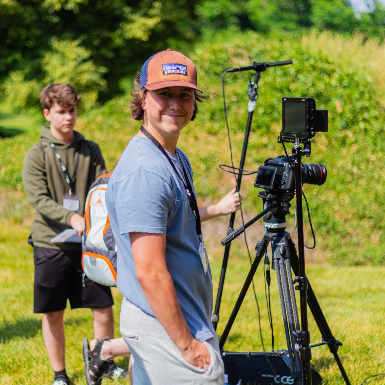DAAPcamp student smiling working on a film project outside.