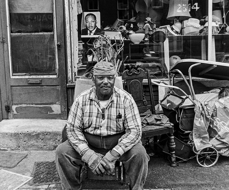 Man sitting outside business